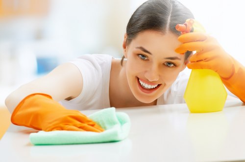 Technician using safe curtain cleaning methods on delicate window drapes